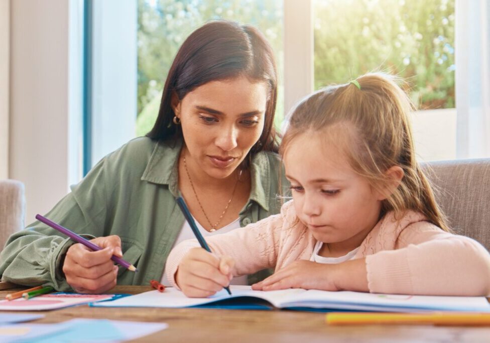 Education, mother and girl with homework, writing and lesson at home, focus and learning. Family, parents and mama with female child, daughter and happy kid with notes, fun or growth with development